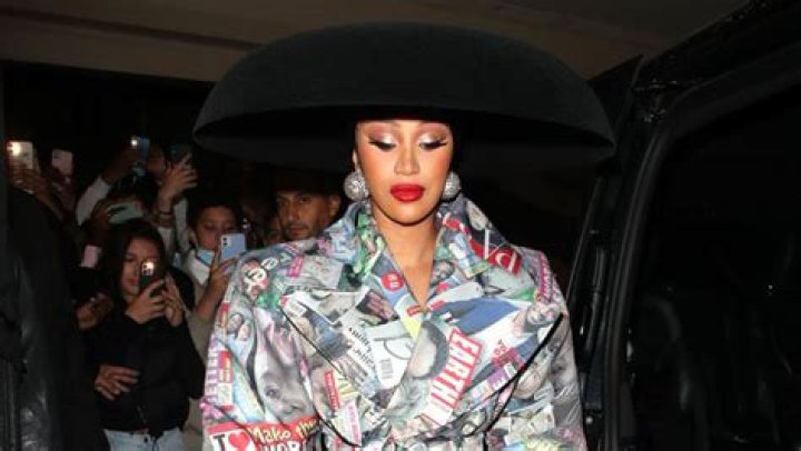 Cardi B Turns Heads In Tabloid Covered Trench Then Lowcut Black Top & Blazer In Paris With Offset