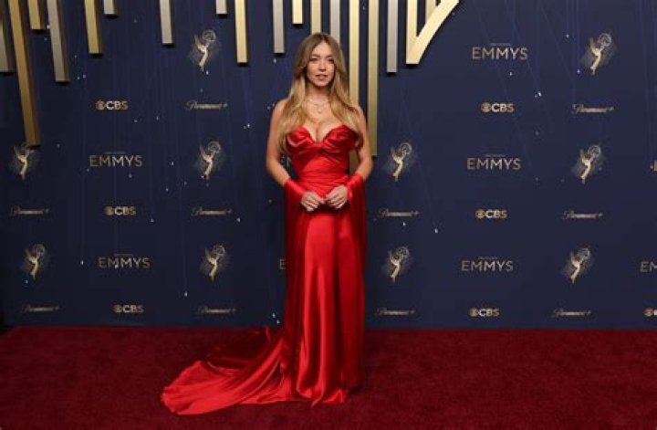 Rita Moreno, 89, Stuns In Burgundy Strapless Gown & Matching Coat At 2021 Oscars