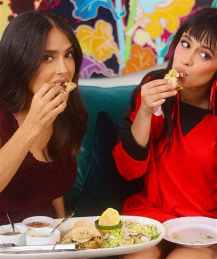 Salma Hayek & Camila Cabello Hilariously Share Tacos on the Couch for National Taco Day: Watch
