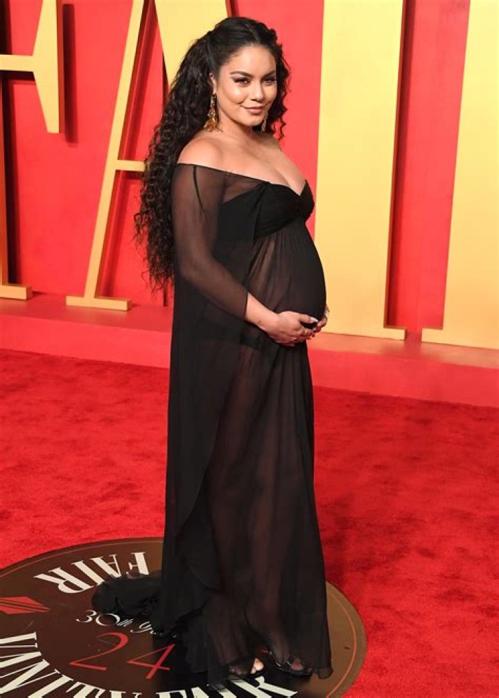 Vanessa Hudgens Cradles Baby Bump in a Stylish Brown Dress: See Photo